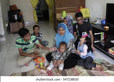 KUALA LUMPUR, MALAYSIA - DECEMBER 27, 2016. A Malaysian Muslim single mother with her children at home in Kuala Lumpur, Malaysia.