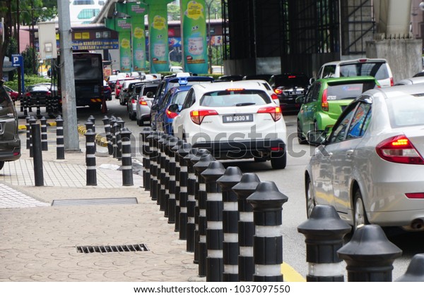 Kuala Lumpur, Malaysia - December 31st 2017:\
Kuala Lumpur heavy traffic pack with cars during rush hour near\
Monorail or train station on a city\
road