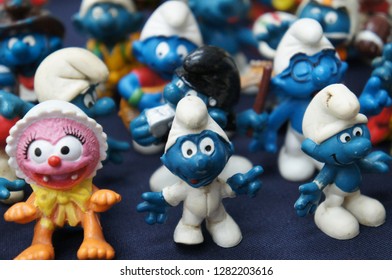 KUALA LUMPUR, MALAYSIA -DECEMBER 9, 2018:  Selective Focused Of Fictional Cartoon Action Figure Smurfs In Miniature Model Displayed For The Public On A Desk. 