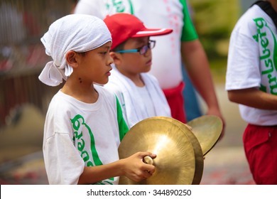 KUALA LUMPUR, MALAYSIA - FEB 19, 2015:  Young Lion Dance Teammate Operating The Musical Instrument Cymbal During Chinese New Year House Visit.