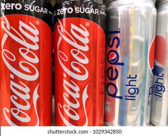 Kuala Lumpur, Malaysia- February 18, 2018: Coca Cola Zero And Pepsi Light Cans On The Supermarket Shelves.