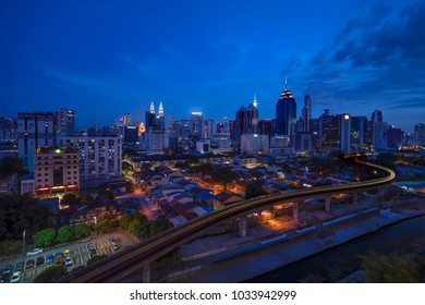 Kuala Lumpur, Malaysia - February 26, 2018: Kuala Lumpur City Skyline At Dusk From Sunway Putra Mall In Kuala Lumpur. The Rapid KL LRT Line In The Foreground.