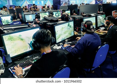 KUALA LUMPUR, MALAYSIA - JANUARY 14, 2018. Unidentified e-Sport players participating in Online Cyber Games Tournament at the cyber cafe in Kuala Lumpur. Low light and high ISO photography.