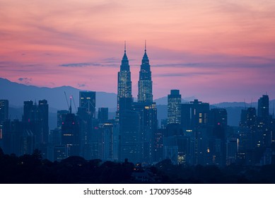 Kuala Lumpur, Malaysia - January 14 2020 : Beautiful Kuala Lumpur City Skyline During Sunrise. The Sky Turns Red-bluish Just Before The Sun Rises Behind The Petronas Twin Towers (KLCC). 