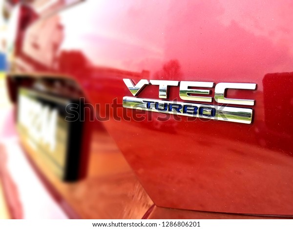 Kuala Lumpur, Malaysia- January 17, 2019: Close up image\
of VTEC Turbo logo on Honda Civic car. VTEC is a system developed\
by Honda to improve the volumetric efficiency of a four-stroke\
engine. 