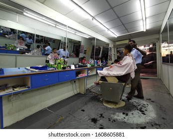 Kuala Lumpur, Malaysia – January, 2020: Young Boy Having His Hair Cut At A Mamak Barbershop. Mamak Barbershop Is Among Favourite Shop For Its Cheap And Professional Services.