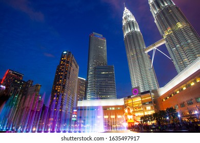 Kuala Lumpur, Malaysia. January 26, 2020: Night view of Petronas Twin Towers KLCC and Symphony Lake, the most attractive place in Malaysia. Beautiful multi colored musical fountains.