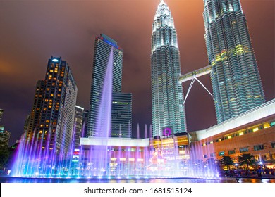 Kuala Lumpur, Malaysia. January 26, 2020: Night view of Petronas Twin Towers KLCC and Symphony Lake, the most attractive place in Malaysia. Beautiful multi colored musical fountains.