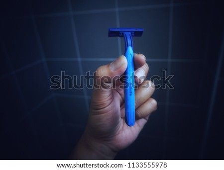 Kuala Lumpur , Malaysia - July 2018 : Hand holding a  Gillete razor blade.