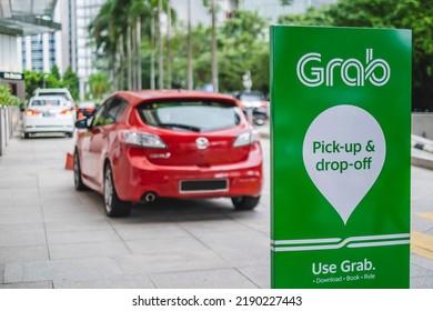 KUALA LUMPUR, MALAYSIA - JULY 27, 2022: An E-hailing Company Logo, Grab Car Display Stand For Pick-up And Drop-off Passengers.