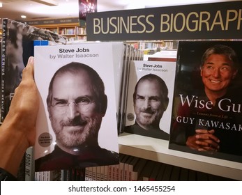 Kuala Lumpur, Malaysia - July 27,2019: Hand Holding A Steve Jobs By Walter Isaacson Book At The Bookstore.