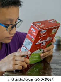 Kuala Lumpur, Malaysia - July 4, 2021 Dr. Oetker Nona Cake Mix Box. A Young Boy Wearing Glasses Reading.