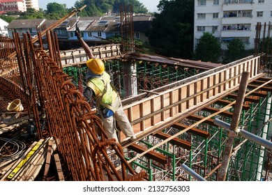 KUALA LUMPUR, MALAYSIA - JULY 7, 2021: Beam and column formwork installed at a construction site. Molds are made of wood and plywood. Be the basis of form to reinforced concrete.

