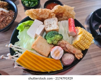 Kuala Lumpur, Malaysia- June 19, 2022 : Variety Of Assorted Steamboat Ingredient Fish Ball, Noodles, Pumpkin, Corn, Bean Curd And Many More At Restaurant Table. Selective Focus.