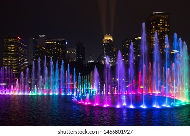 Kuala Lumpur, Malaysia - June 2018: Beautiful colorful musical fountain at night with background of Petronas Twin Towers and Suria KLCC. Petronas Twin Tower is the highest building in Malaysia 452m