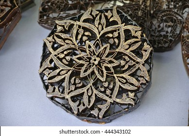 KUALA LUMPUR, MALAYSIA -JUNE 25, 2016: Mold or pattern block of Batik Tekap or Stamp Batik. The block was made from copper to maintain its pattern and to guarentee it durability againt hot wax. 