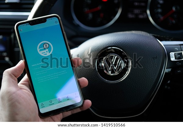 KUALA LUMPUR, MALAYSIA - JUNE 6TH, 2019:\
modern lifestyle with smartphone to stay connected and browsing\
favourite Apps. Find Gas/Petrol Station and makes online payment\
via SETEL apps on\
Smartphone