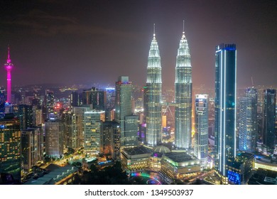 Kuala Lumpur, Malaysia. Mar 25, 2019. Aerial Night View Of Petronas Twin Towers In KLCC Area. Previously Known As Tallest Building In The World. The Picture May Have Soft And Grain Effect.