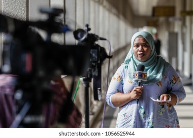 KUALA LUMPUR, MALAYSIA - MARCH 28, 2018. A Muslim Female Reporter Doing A Live Reporting At The Kuala Lumpur Court House In Kuala Lumpur, Malaysia.