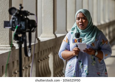 KUALA LUMPUR, MALAYSIA - MARCH 28, 2018. A Muslim Female Reporter Doing A Live Reporting At The Kuala Lumpur Court House In Kuala Lumpur, Malaysia.