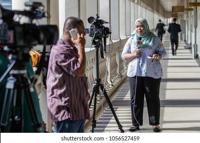 KUALA LUMPUR, MALAYSIA - MARCH 28, 2018. A Muslim Female Reporter Doing A Live Reporting At The Kuala Lumpur Court House In Kuala Lumpur, Malaysia.