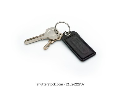Kuala Lumpur, Malaysia - March 6 2022. Keys attached to a key chain on white background. Design element, top view, flat lay. Ideal  for graphic design background wallpaper. Plenty of space for texts.