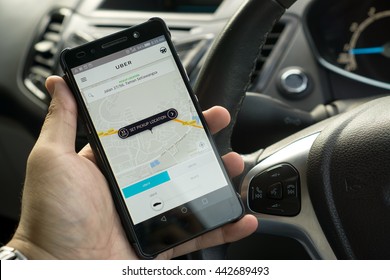 KUALA LUMPUR, MALAYSIA - MAY 31ST, 2016: modern lifestyle with smartphone to stay connected and browsing favourite Apps. Make your travel easy with UBER. Be a driver or a passenger.