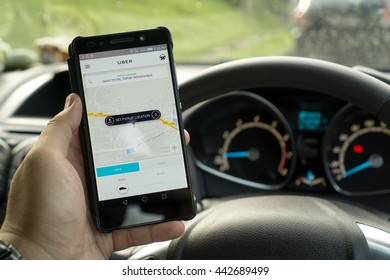 KUALA LUMPUR, MALAYSIA - MAY 31ST, 2016: modern lifestyle with smartphone to stay connected and browsing favourite Apps. Make your travel easy with UBER. Be a driver or a passenger.