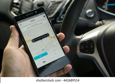 KUALA LUMPUR, MALAYSIA - MAY 31ST, 2016: Modern Lifestyle With Smartphone To Stay Connected And Browsing Favourite Apps. Make Your Travel Easy With UBER. Be A Driver Or A Passenger.