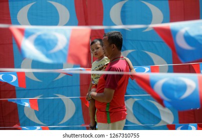 Kuala Lumpur, Malaysia - May23,2018 : A Man With He Baby Cross  The Flag Peoples Justice Party (PKR)