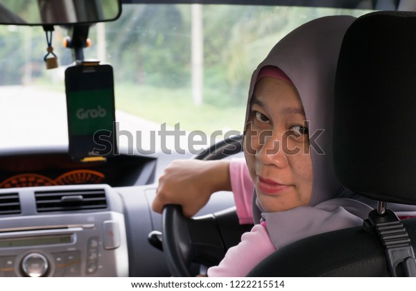 KUALA LUMPUR, MALAYSIA NOVEMBER 04 2018 :\
Asian woman driving car to travel or\
grab.