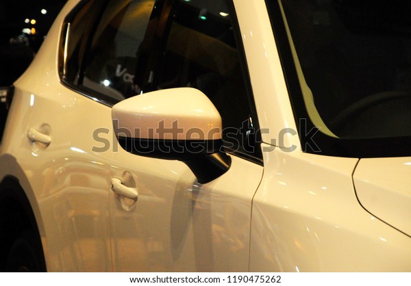 KUALA\
LUMPUR, MALAYSIA -NOVEMBER 12, 2017: Car side mirror or door mirror\
build at exterior of car for the purposes of helping the driver see\
areas behind and to the sides of the\
vehicle.