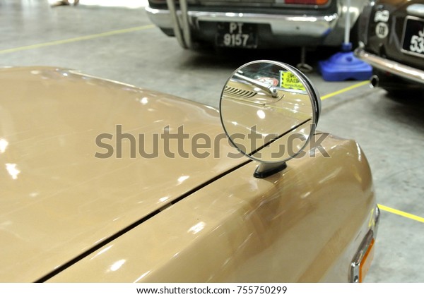 KUALA\
LUMPUR, MALAYSIA -NOVEMBER 12, 2017: Car side mirror or door mirror\
build at extrior of car for the purposes of helping the driver see\
areas behind and to the sides of the\
vehicle.