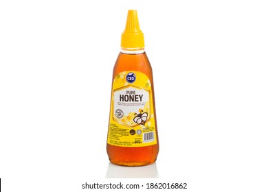 Kuala Lumpur, Malaysia - November 2020. Fresh honey in a bottle ready to be serve and eat. Isolated honey over white background.