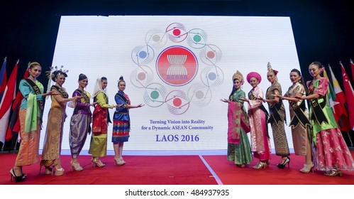 KUALA LUMPUR, MALAYSIA - NOVEMBER 22, 2015 : Woman Wearing Traditional Dress Of ASEAN Countries, Welcome Delegates To ASEAN Meeting 2016 Laos.