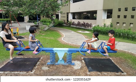 Kuala Lumpur / Malaysia - November 4 2018: Asian Children Playing See Saw