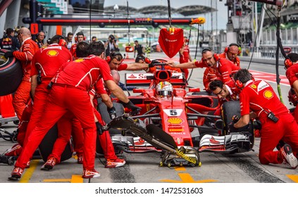 KUALA LUMPUR, MALAYSIA - OCTOBER 1, 2017 : Sebastian Vettel (Germany) making a pitstop in the Scuderia Ferrari SF71H F1 2018 car during the F1 at Sepang Circuit.