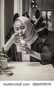 Kuala Lumpur, Malaysia - September 2 2020 : Young beautiful Muslim girl wearing hijab and casual dress outdoor.Hijab fashion on the ais cream shop.