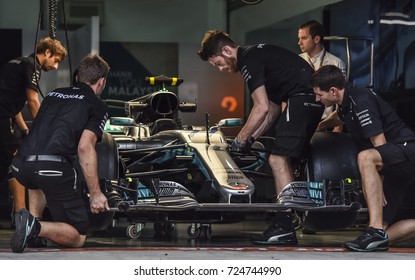 KUALA LUMPUR, MALAYSIA - SEPTEMBER 28, 2017 : Team mechanics work on Mercedes AMG racer Lewis Hamilton's car during Malaysia Formula One Grand Prix at Sepang Circuit.