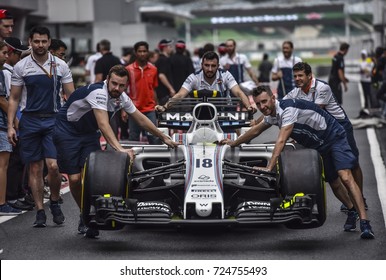 KUALA LUMPUR, MALAYSIA - SEPTEMBER 28, 2017 : Team mechanics work on William Martini Racing Lance Stroll racer car during Malaysia Formula One Grand Prix at Sepang Circuit.