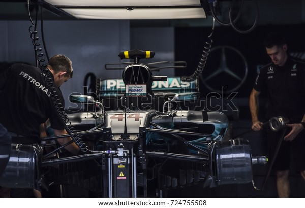 KUALA LUMPUR, MALAYSIA -\
SEPTEMBER 28, 2017 : Team mechanics work on Mercedes AMG racer\
Lewis Hamilton\'s car during Malaysia Formula One Grand Prix at\
Sepang Circuit.