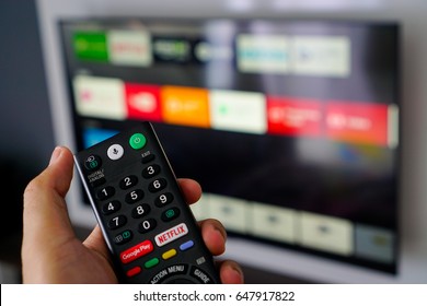 Kuala Lumpur - May 27th 2017 : Android TV home-user are using Google Voice Search (OK Google) function on Sony Remote by speaking to search for media, movie, music or any content on Internet.
