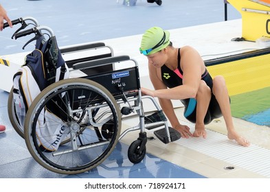 KUALA LUMPUR - SEPTEMBER 20, 2017: Athletes with disabilities rise after playing in swimming at the 9th ASEAN Para Games on September 20, 2017 at the National Aquatic Center, Malaysia. - Shutterstock ID 718924171