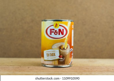 KUALA LUMPUR,MALAYSIA- JUNE 10,2018: F&N condensed milk sweet creamer on wooden background. F&N creamer is a important ingredient to make famous Malaysian drink known as teh tarik.  - Shutterstock ID 1109910590
