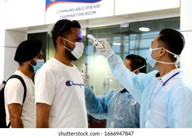 Kuala Lumpur/Malaysia-March 05,2020.
Malaysian Health Ministry Officers Use A Thermal Scanner To Check The Temperatures Of Passengers Arriving At The Kuala Lumpur International Airport.