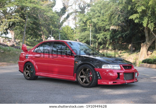 Kuala Selangor, Selangor, Malaysia - 1st June\
2019: Selective focus image of red car Mitsubishi Lancer\
\
Evolution 5 parks at\
outdoor