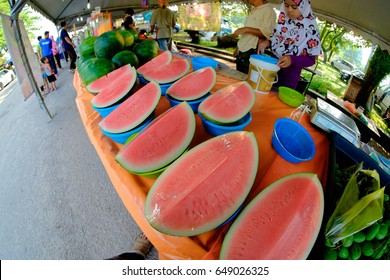 Kuantan,Malaysia -May 28,2017:Watermelon  On Sale By Local  Girl  At The Ramadhan Bazaar In Kuantan, Malaysia.The Bazaar Is A Famous Market Offering Varied Malay Food For Iftar .