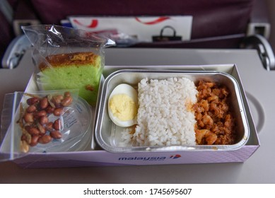 Kuching, Sarawak / Malaysia - February 24, 2017: Nasi Lemak And Cake In A Takeaway Box On Board Malaysia Airlines Flight.