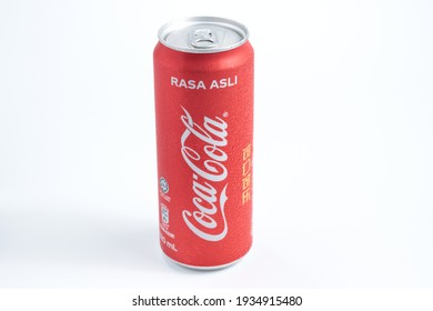 Kuching,Malaysia. 13 March 2021. A cold Malaysian version Coca - Cola can with malay lettering translated to "original taste". isolated in white background.