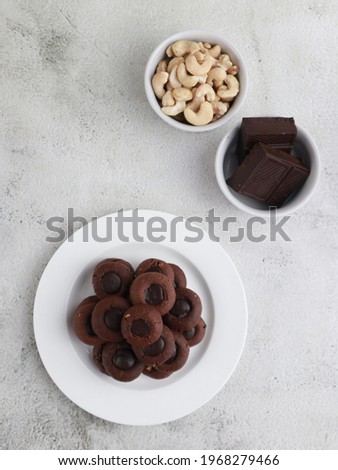Kue coklat or Chocolate cookies or choco button cookies for Lebaran. Made from butter, egg, dark cooking chocolate, flour, cocoa pwder and cashew nut. Selective focus. 